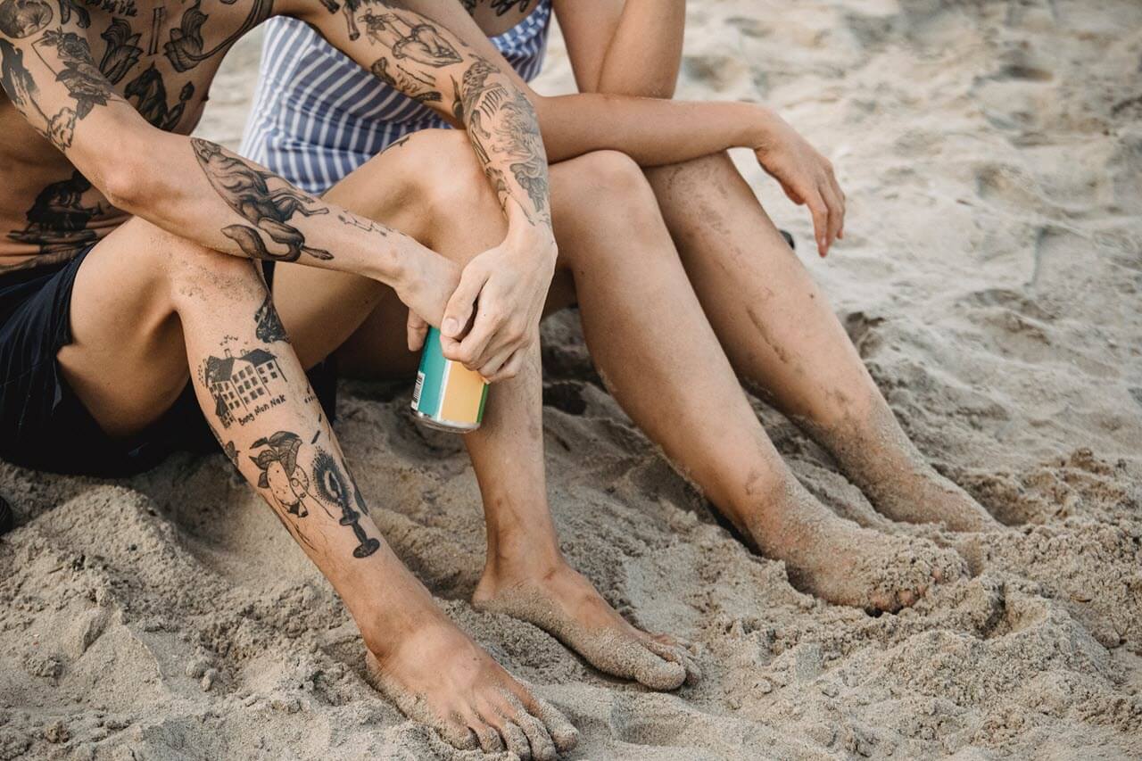 People with tattoos on beach